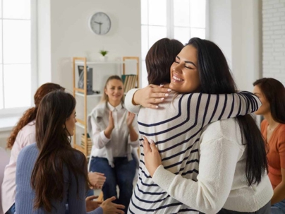 Two women hugging at a divorce support group