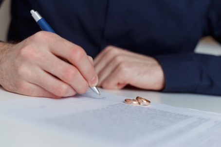 person signing divorce papers