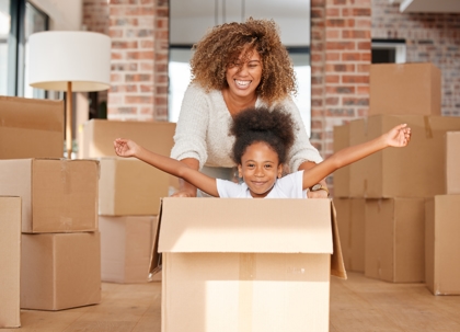 mother and daughter playing with moving boxes